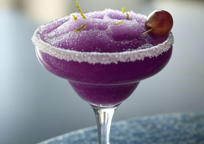 “Frozen transfusion drink slush with grape garnish in a margarita glass.”