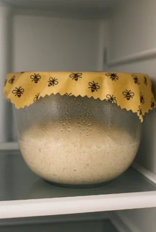 "Sourdough dough fermenting overnight in fridge inside a glass bowl"